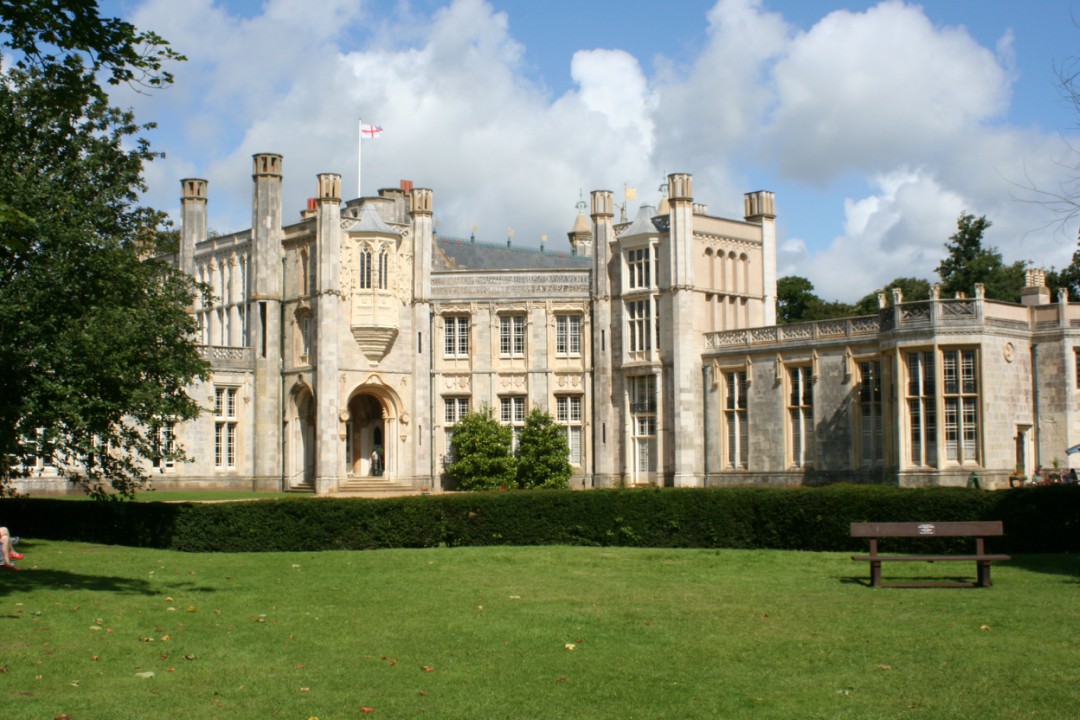 Highcliffe Castle in Christchurch on a warm afternoon with a blue, cloudy sky overhead